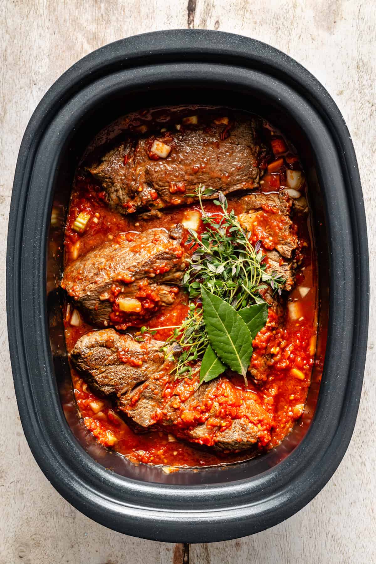 beef ragu ingredients in a slow cooker.