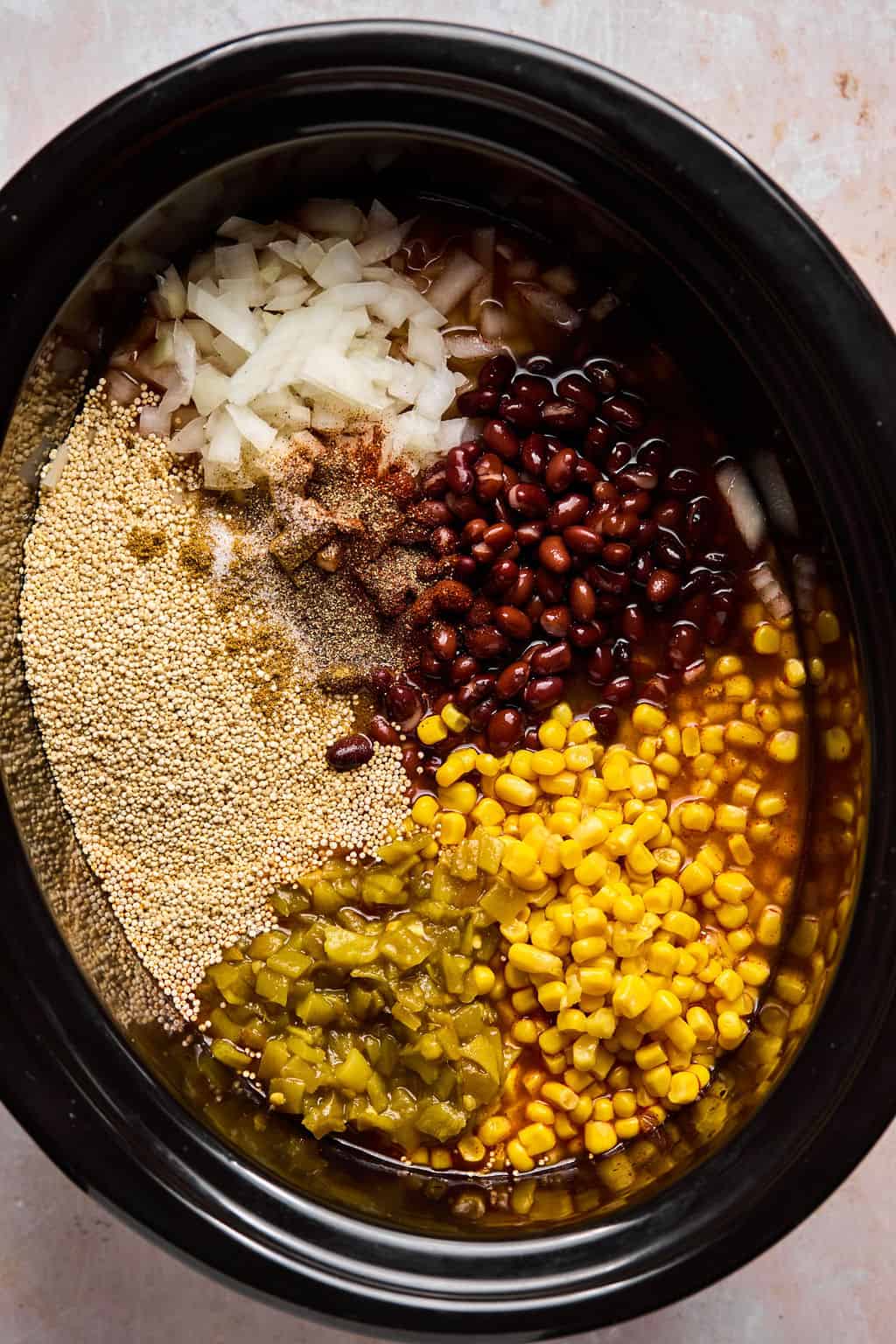 ingredients for taco casserole in a crock pot.