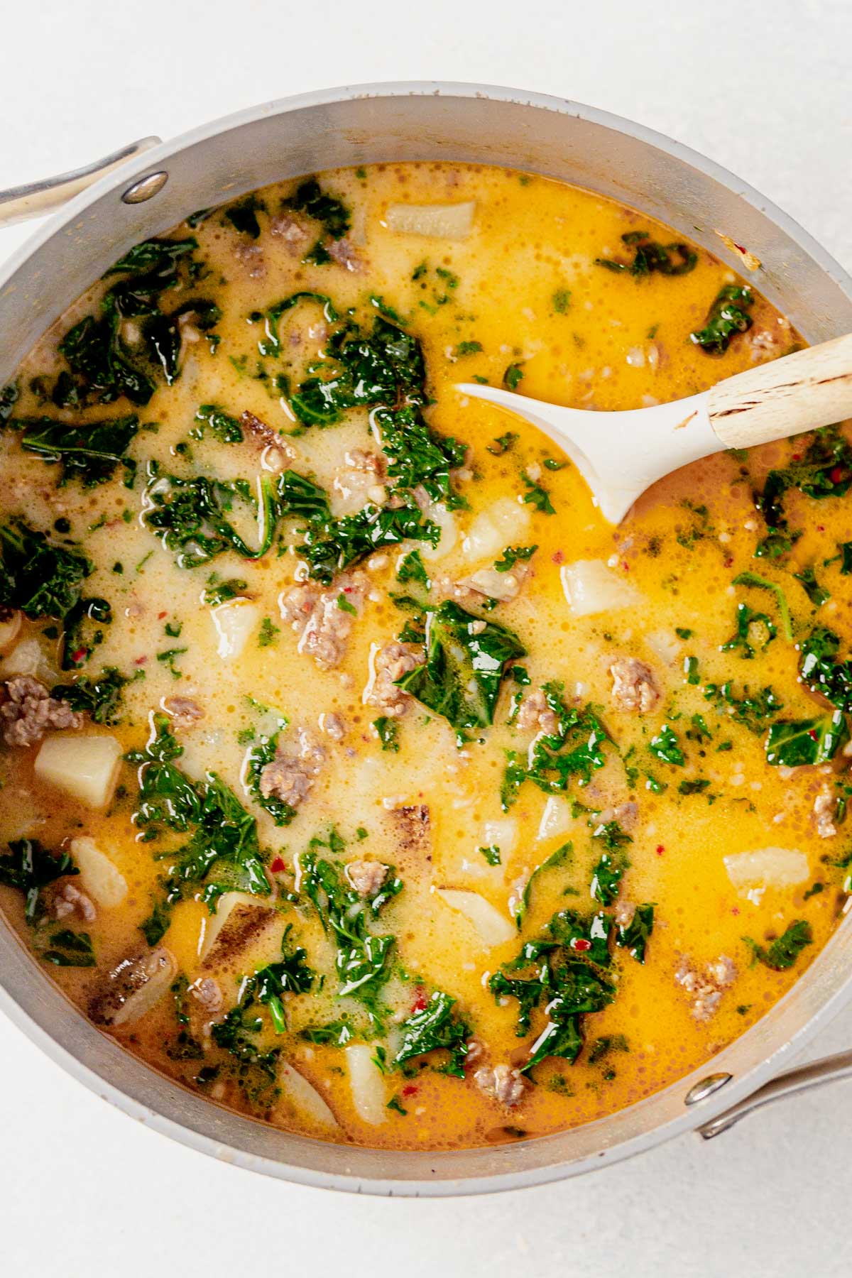 creamy whole30 zuppa toscana mixed with kale and coconut cream