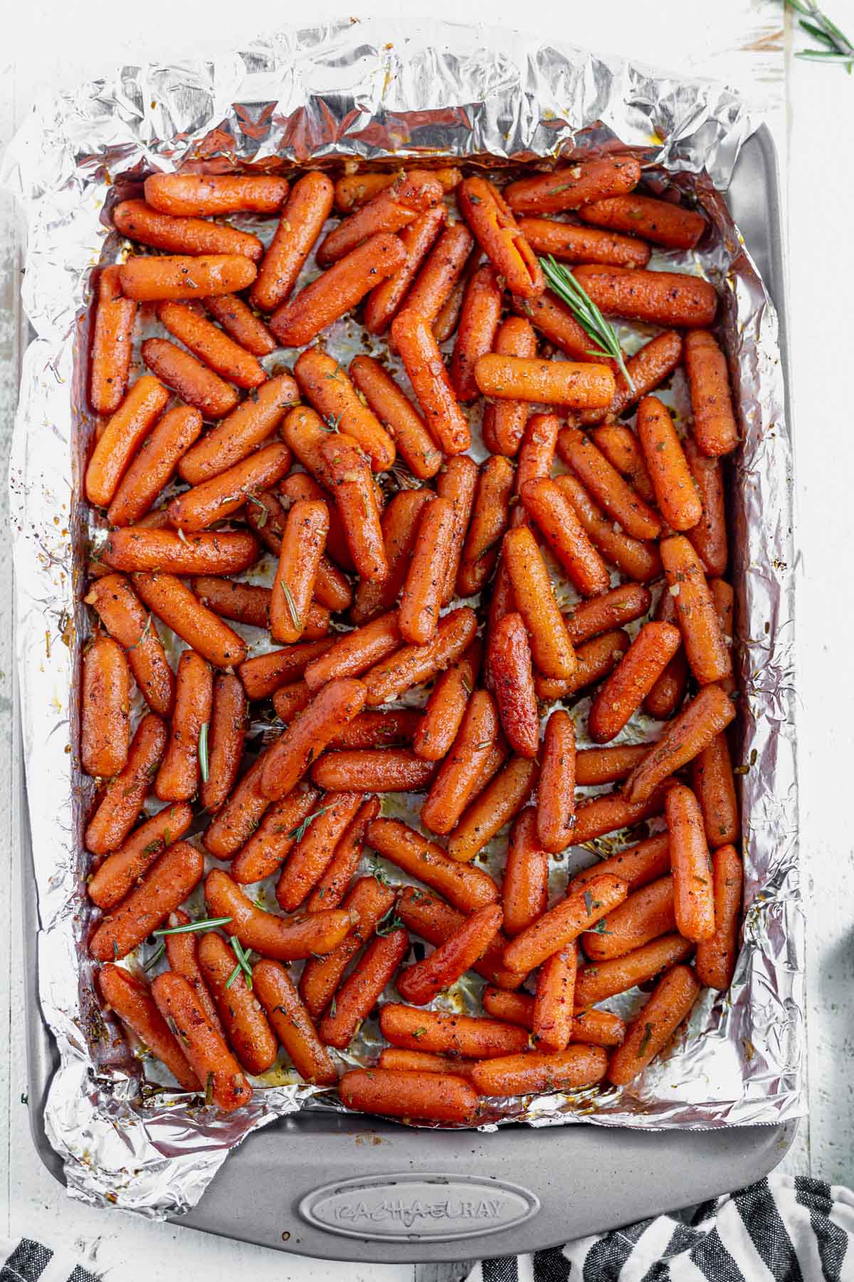 a rimmed baking sheet lined with foil filled with maple roasted carrots