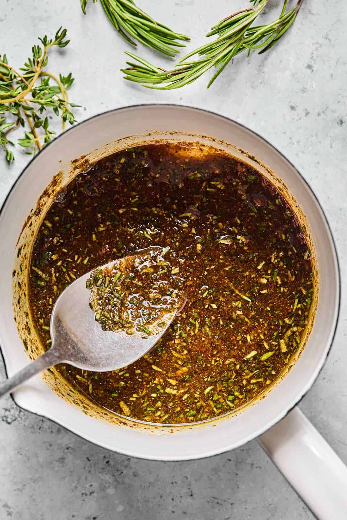stirring rosemary and spices into olive oil in a saucepan.