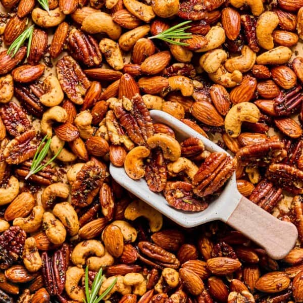 scooping up rosemary spiced nots from a sheet pan.