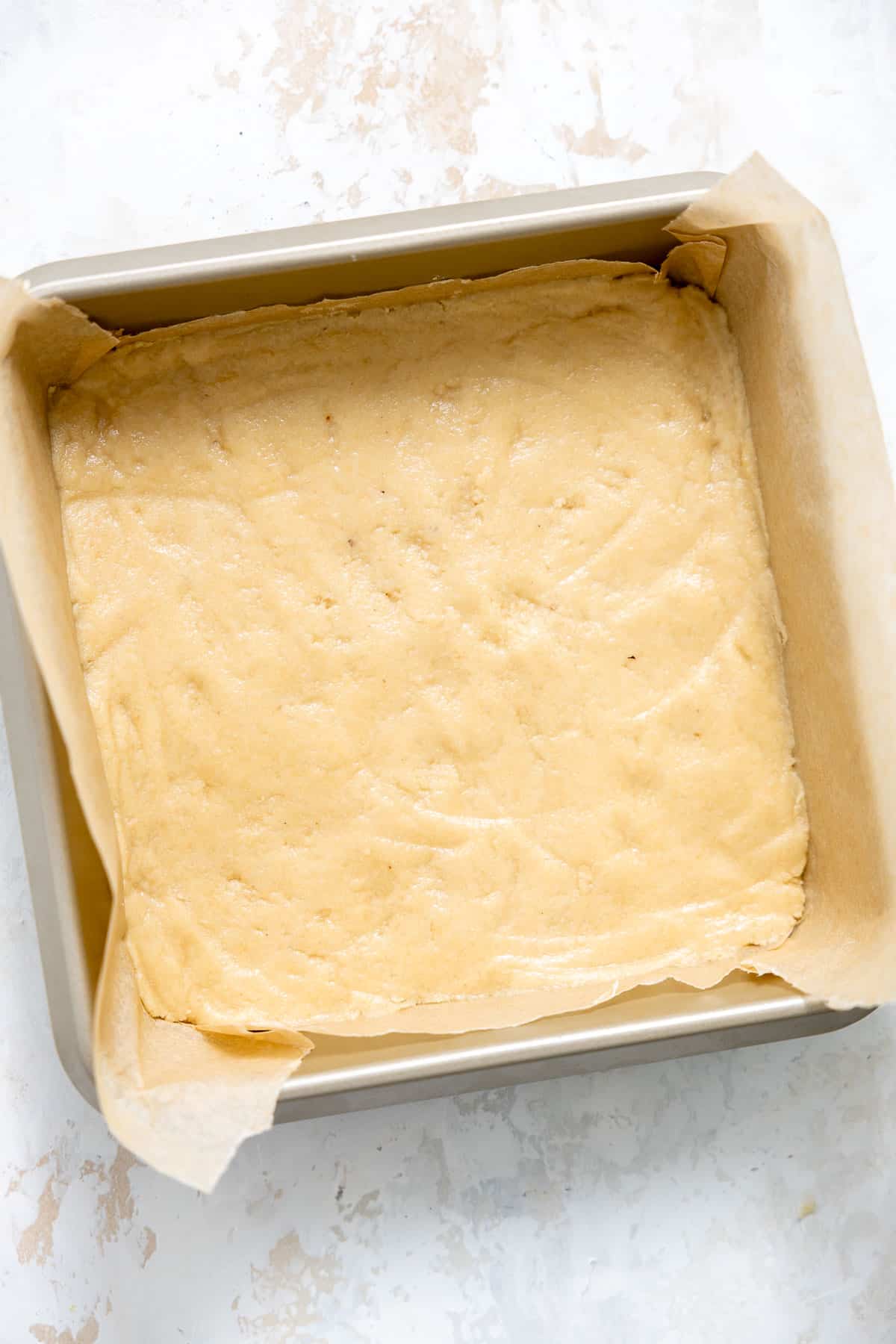 gluten free paleo shortbread dough pressed into a baking dish.