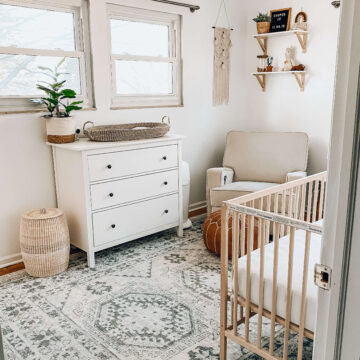 picture of neutral boho nursery with natural wood crib, white dresser and boho accents