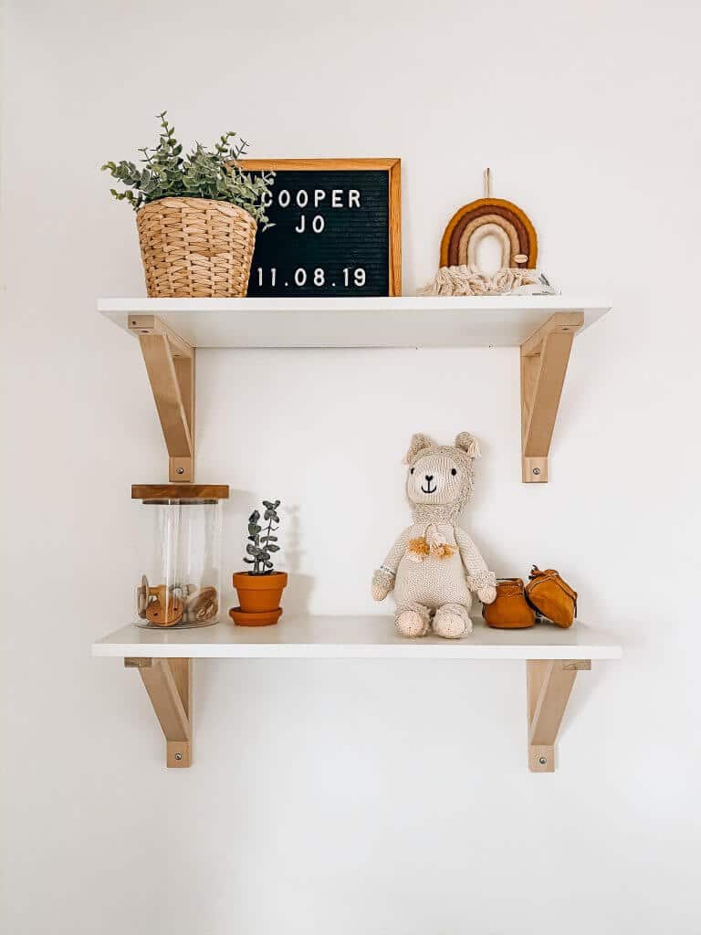 white and wood modern shelves for boho nursery from ikea with decor on top