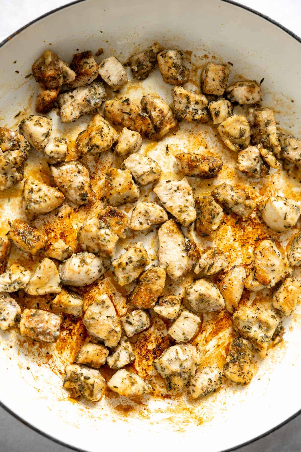 crispy cajun seasoned chicken pieces in a skillet.