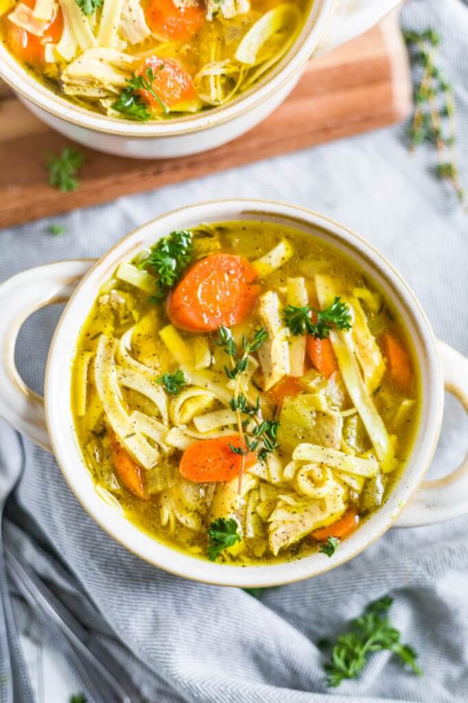 the best instant pot chicken noodle soup with carrots, shredded chicken and topped with fresh parsley