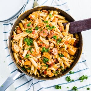 one pot creamy cajun chicken pasta in a pan on a kitchen towel