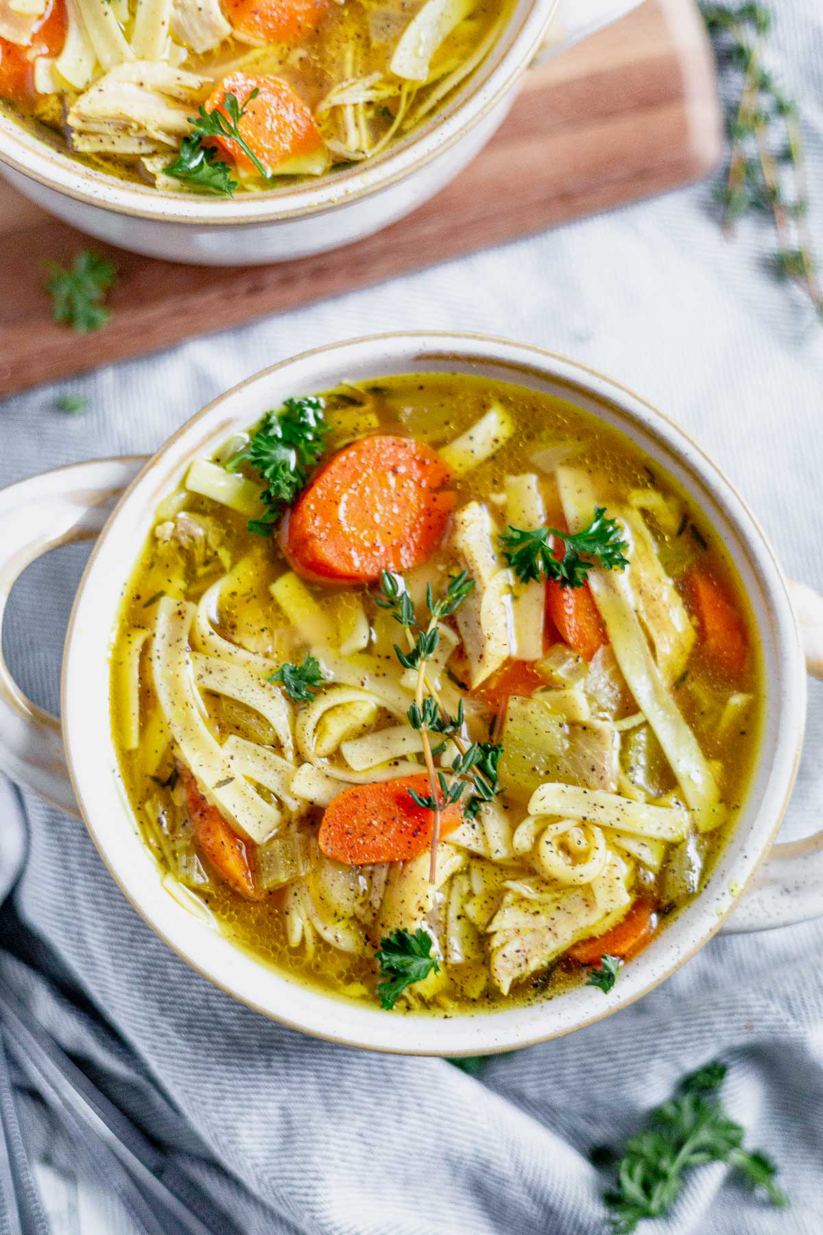 close up picture of homemade chicken noodle soup from the instant pot in a white bowl