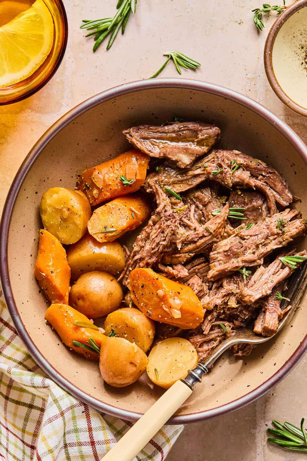 a serving of instant pot chuck roast in a bowl with potatoes and carrots.