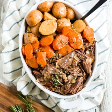 instant pot chuck roast shredded in a bowl with carrots and potatoes