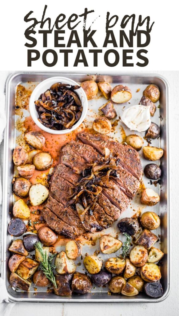 steak and potatoes on a sheet pan with garlic and herbs