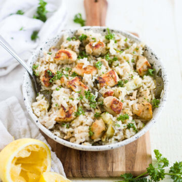 instant pot greek chicken and rice in a bowl with fresh lemon and parsley