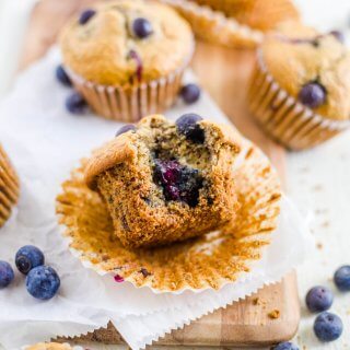blueberry lactation muffin on the table with a bite taken out of it