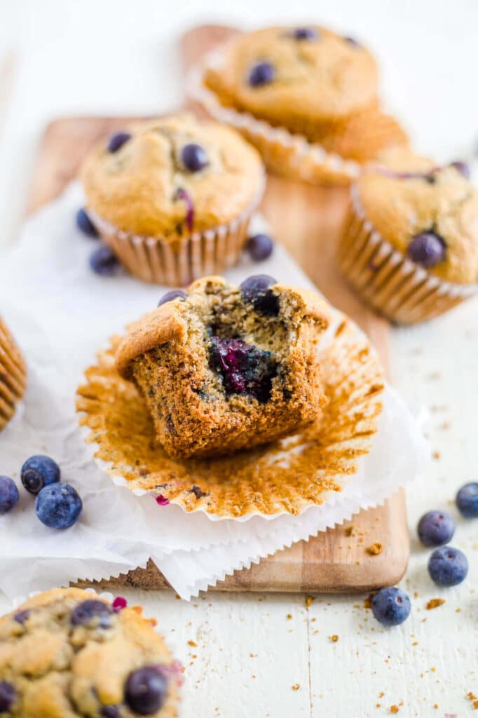 blueberry lactation muffin on the table with a bite taken out of it