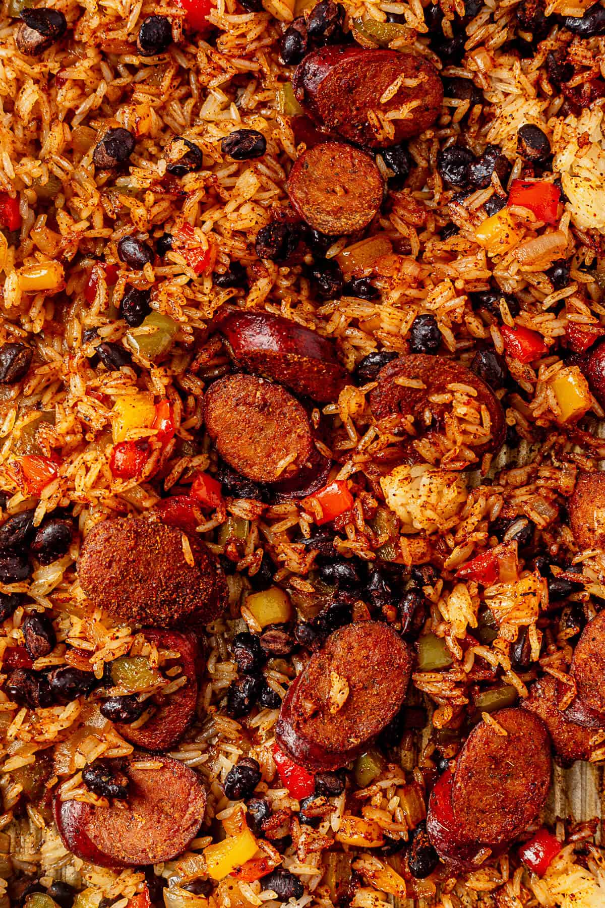 mexican chicken, rice, blacke beans and peppers on a sheet pan