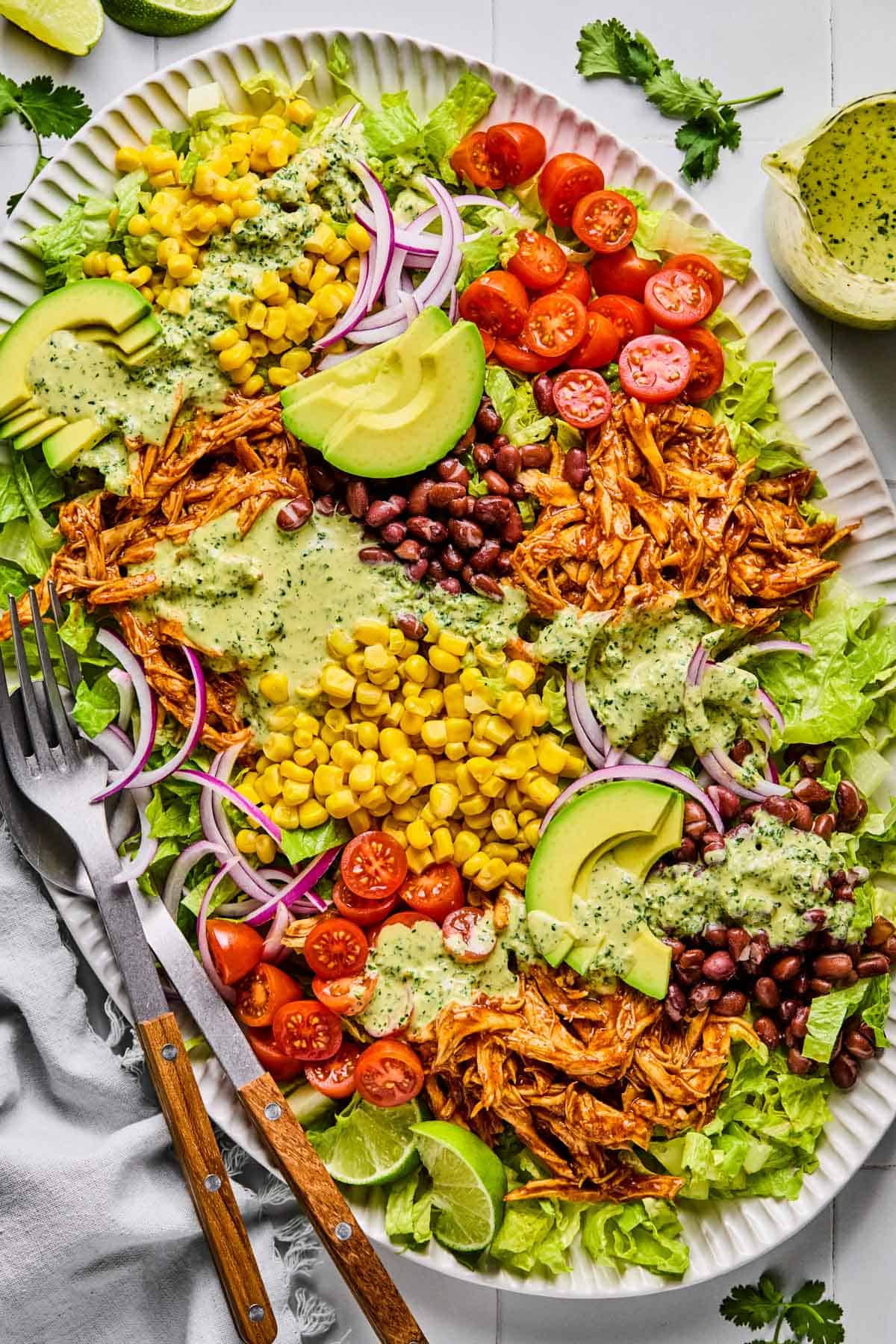 barbeque chicken salad with creamy cilantro jalapeno dressing poured overtop