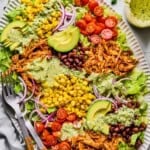 bbq chicken salad with cilantro dressing poured on top.