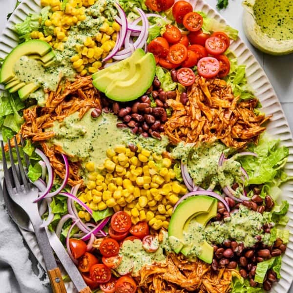 bbq chicken salad with cilantro dressing poured on top.