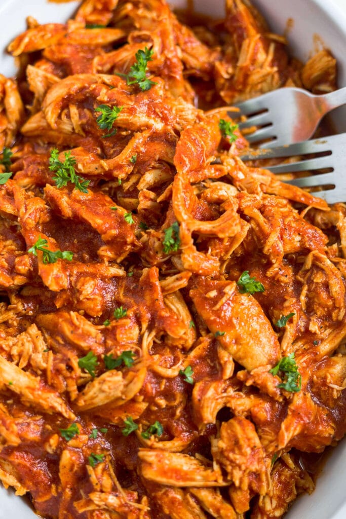 bbq pulled chicken in a dish with two forks