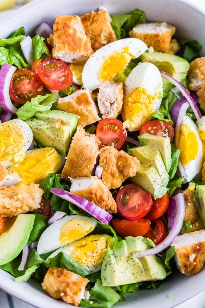 crispy chicken salad in a white bowl