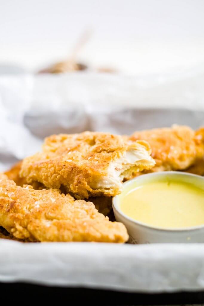 gluten free chicken tenders with one of them with a bite taken out