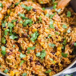 mexican beef and rice in a skillet with a spatula