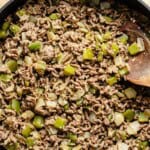ground beef cooked with onion and peppers in a pan.