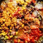 mexican beef and rice ingredients mixed in one skillet.