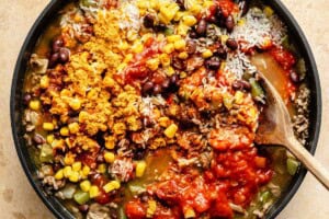mexican beef and rice ingredients mixed in one skillet.