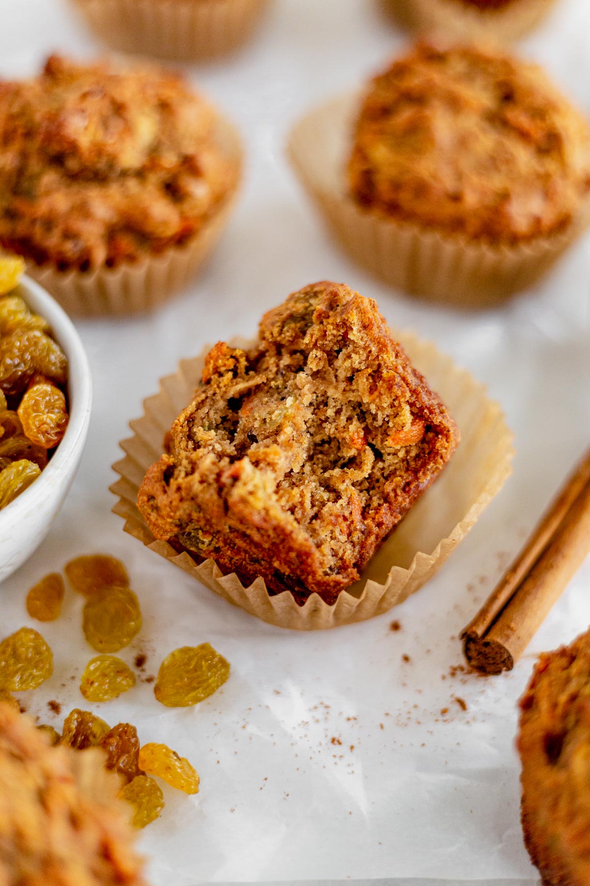 gluten free morning glory muffin in the wrapper with a bite taken out