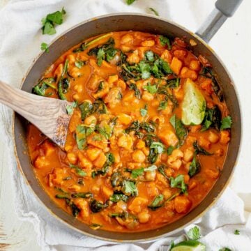 sweet potato curry recipe in a pot with a wooden spoon