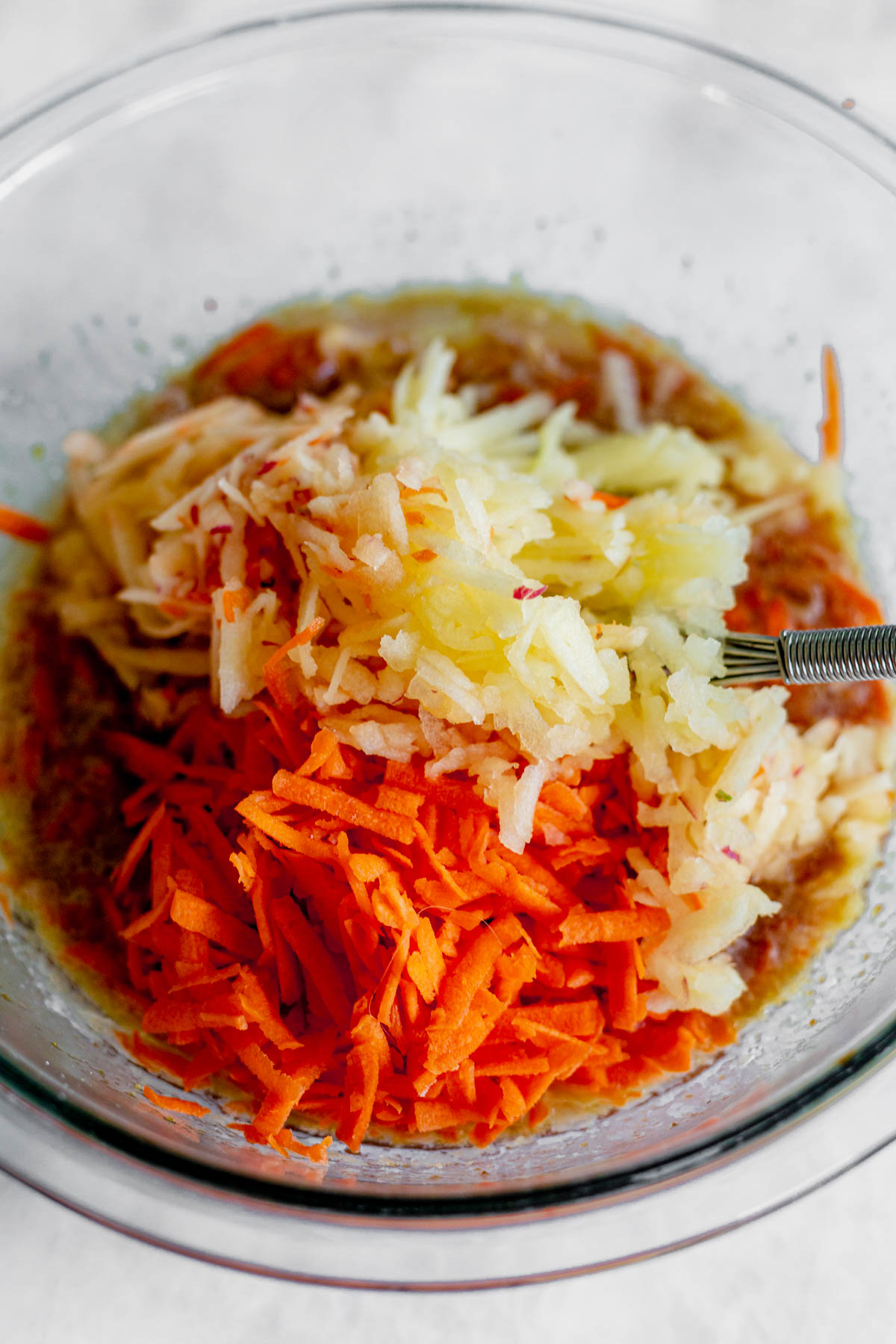 shredded apples, carrots and other wet ingredients for gluten free morning glory muffins