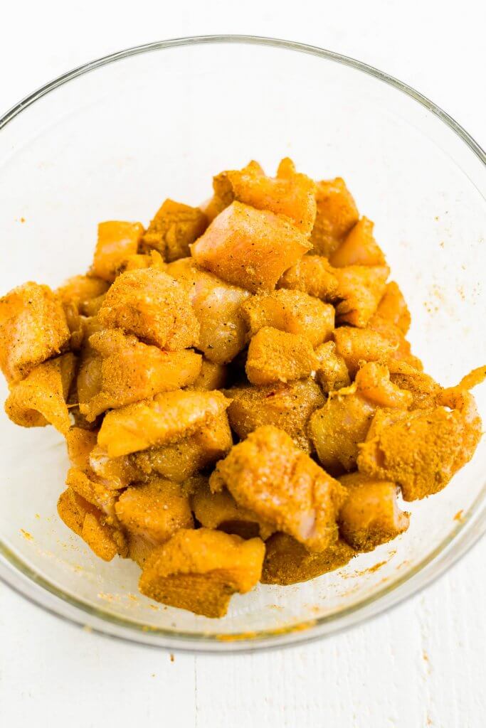 diced chicken in a bowl with indian curry spices