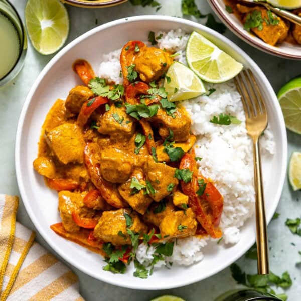 coconut curry chicken in a bowl with fresh cilantro and basmati rice.