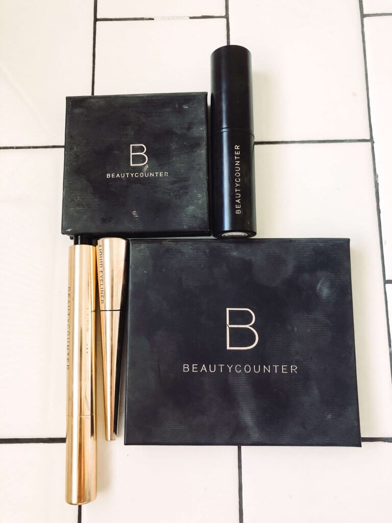 4 beauty counter products on white subway tile