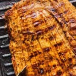 pineapple marinated flank steak on a grill.