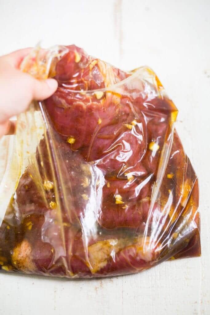 flank steak marinading in a plastic bag