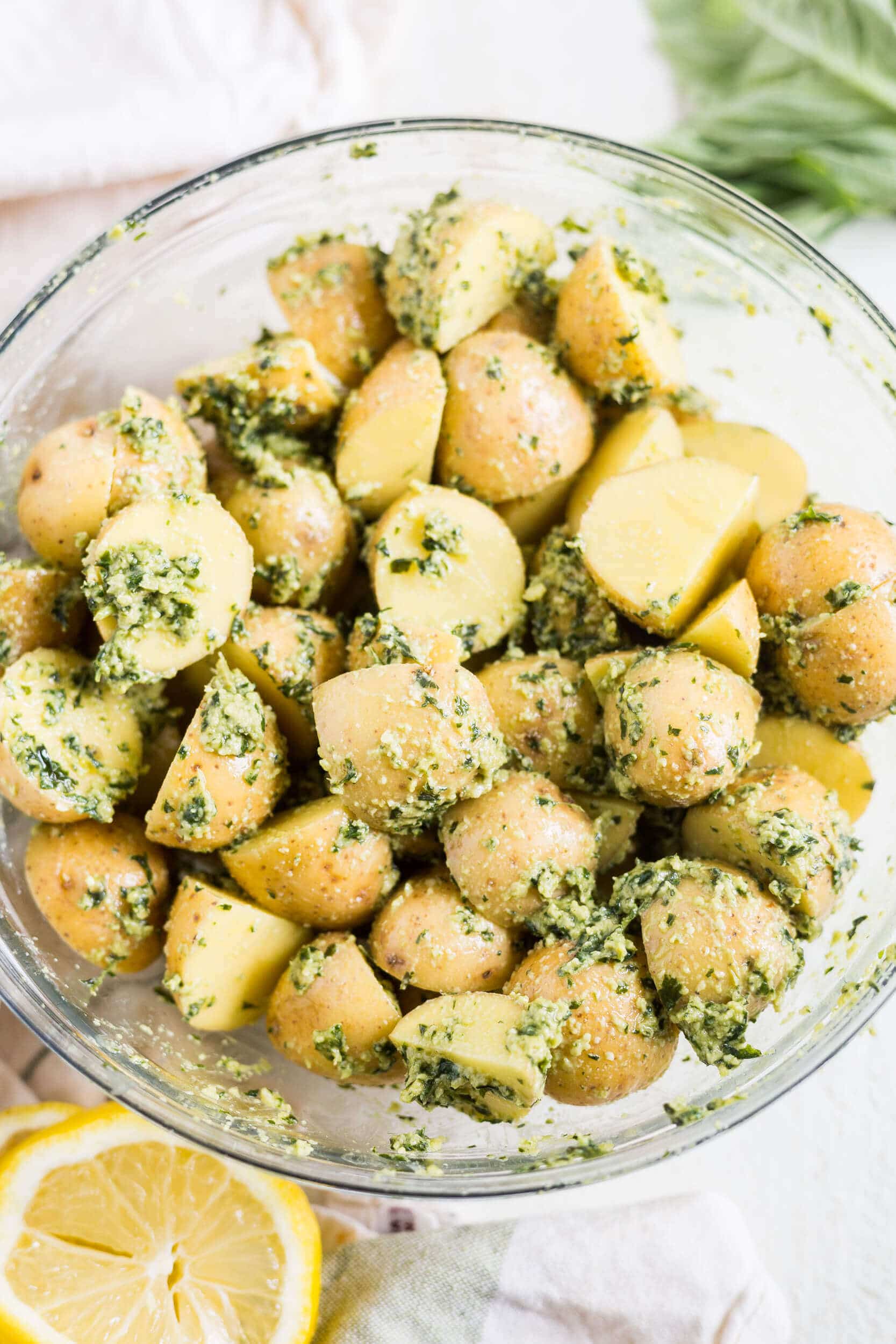 baby potatoes in a glass bowl with pesto
