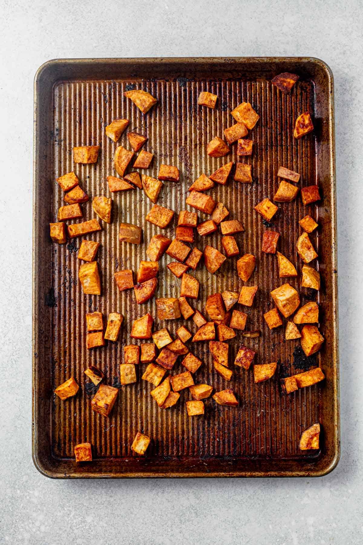 roasted diced sweet potatoes on a sheet pan.