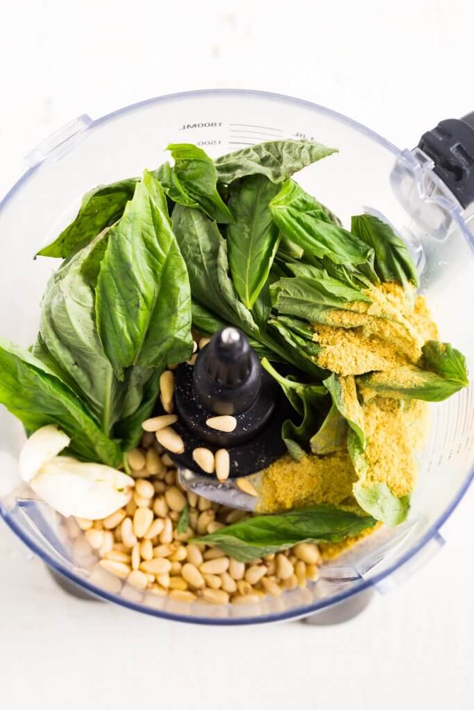 ingredients for vegan pesto in the bowl of a food processor