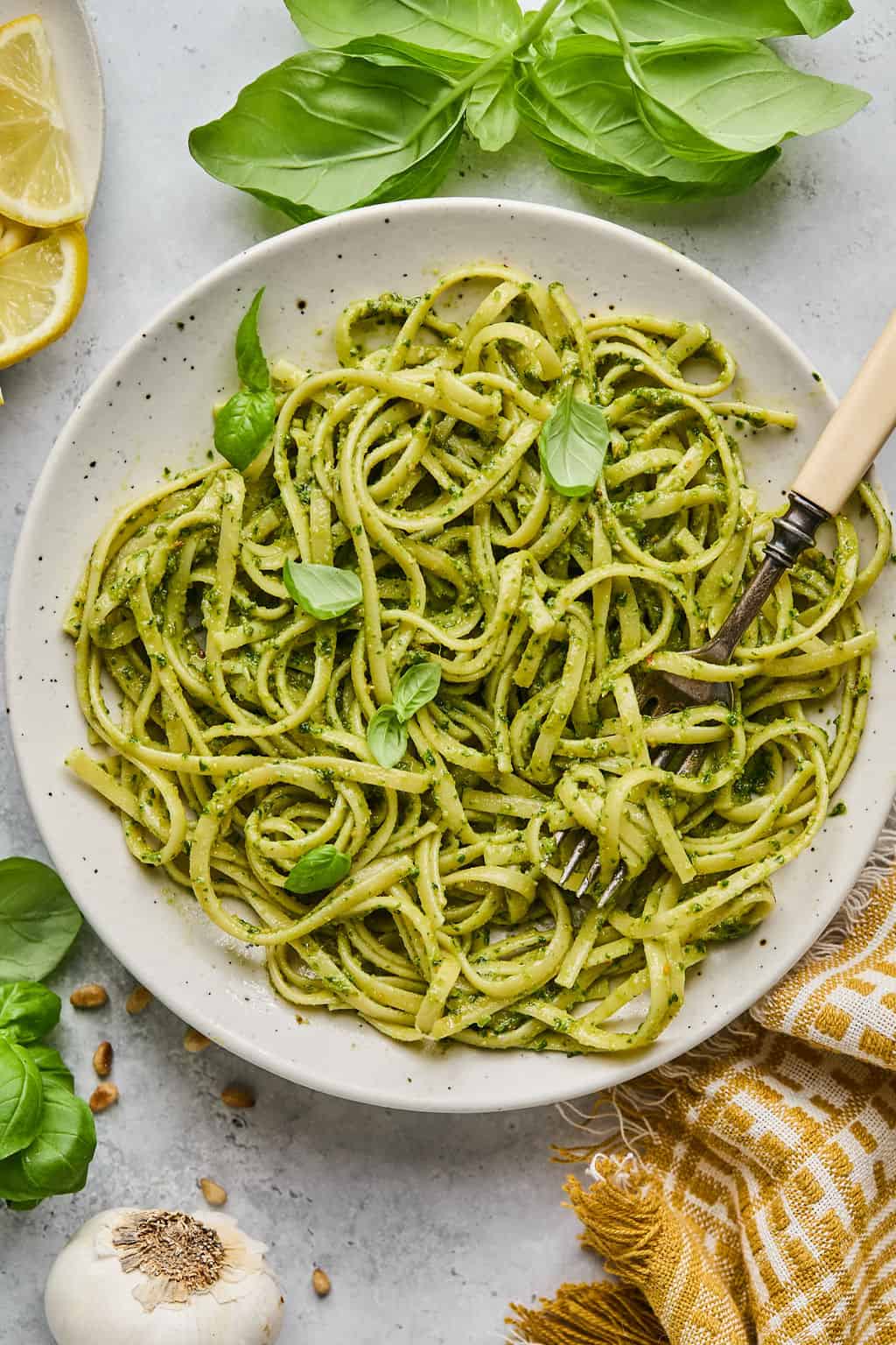 a bowl of noodles tossed in vegan pesto.