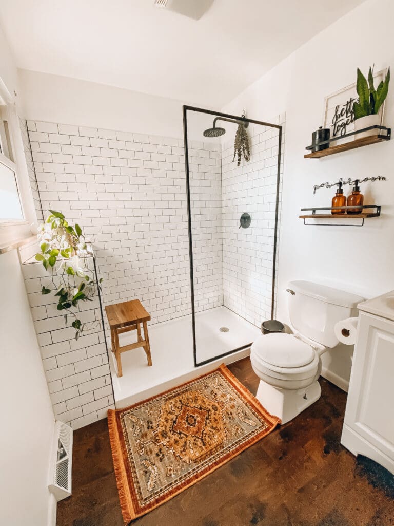 modern farmhouse bathroom update reveal with wood floors, walk in shower and open shelves
