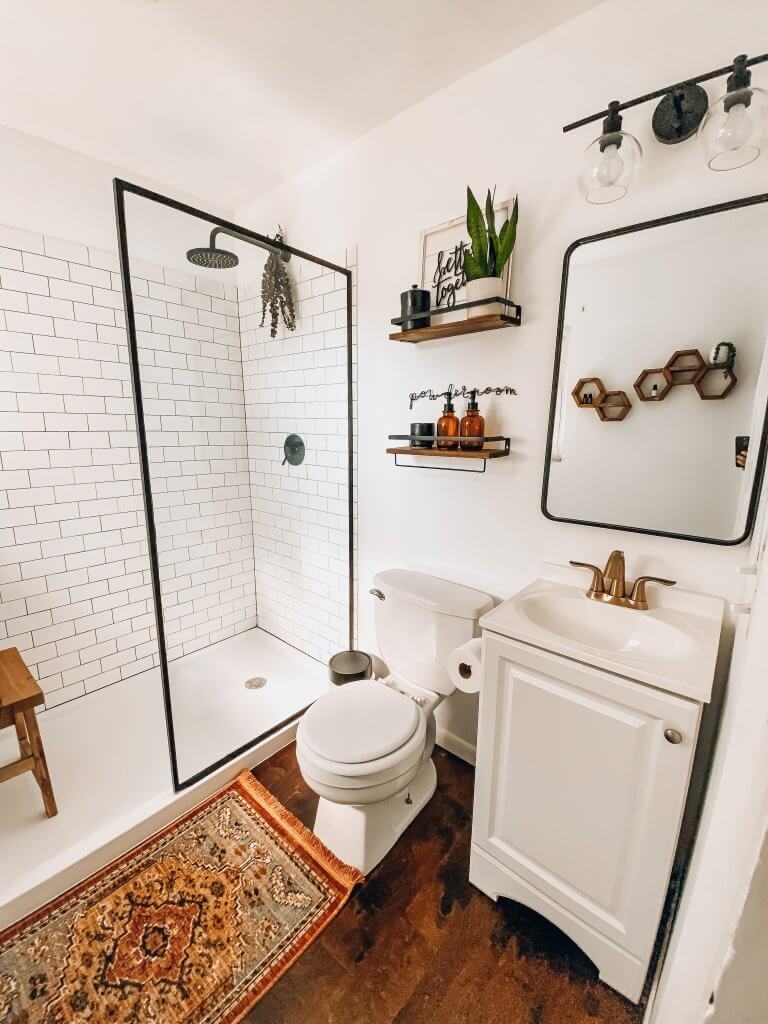 modern farmhouse bathroom remodel with subway tile shower and plants