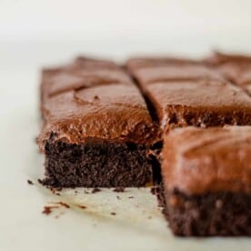 sweet potato chocolate cake on parchment paper with chocolate frosting