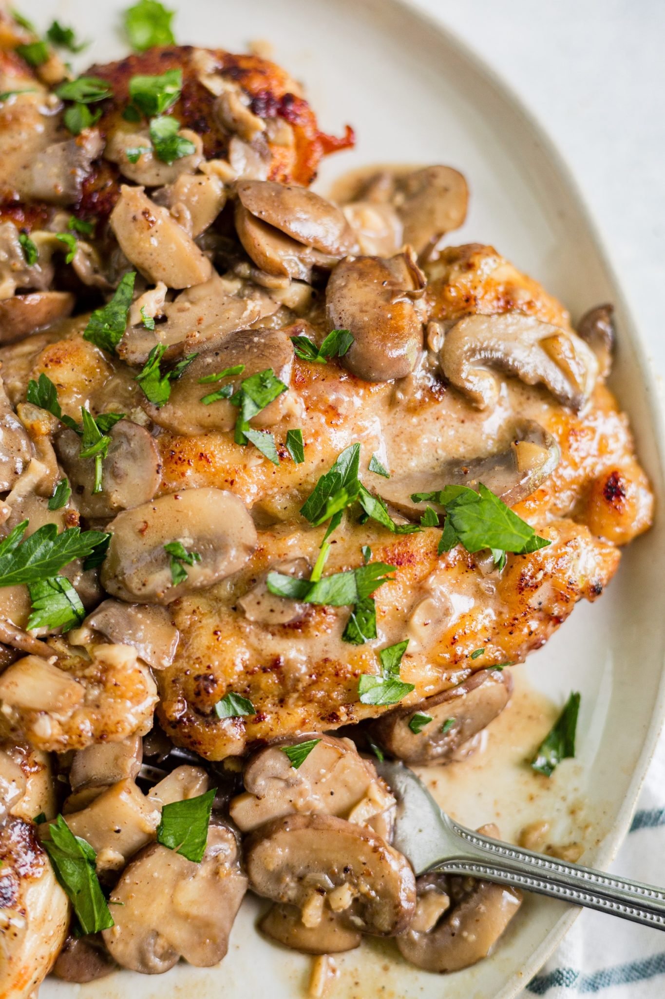 healthy chicken marsala on a plate with a fork
