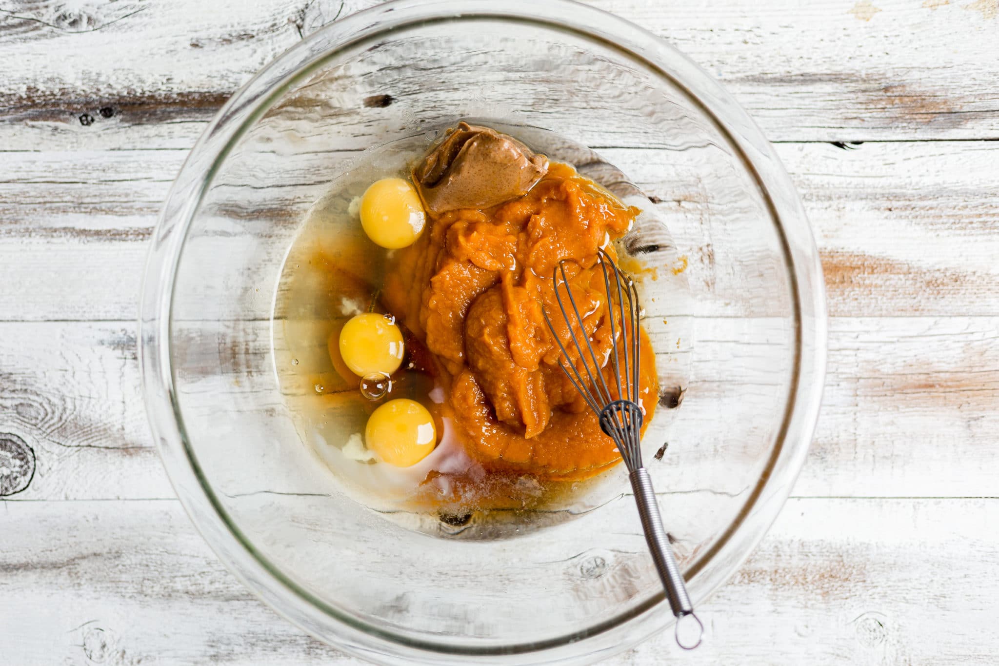 eggs, pumpkin puree, coconut sugar, and vanilla in a bowl.