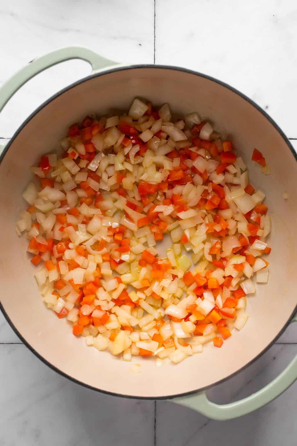 peppers and onion cooking on a soup pot.