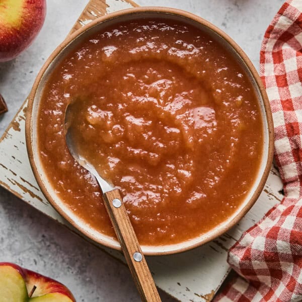 a bowl of crock pot applesauce with a spoon.