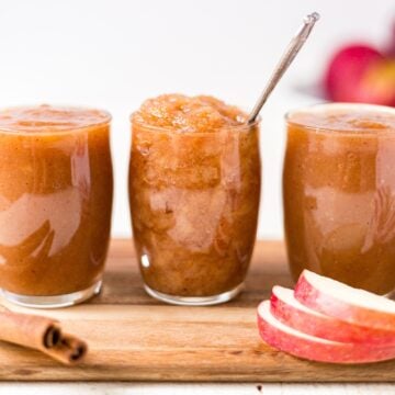 homemade crockpot applesauce in a jar with a spoon